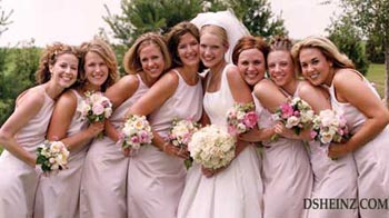 A happy group of bride's maids, the bride, and flowers