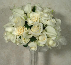 White roses, gardenias, and calla lilies in a beautiful bridal bouquet