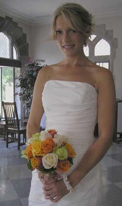 A happy bride with a colorful rose bouquet