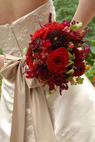 Rich red roses and dahlias with hypericin accents