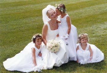 Three flower girls with floral crowns and the bride